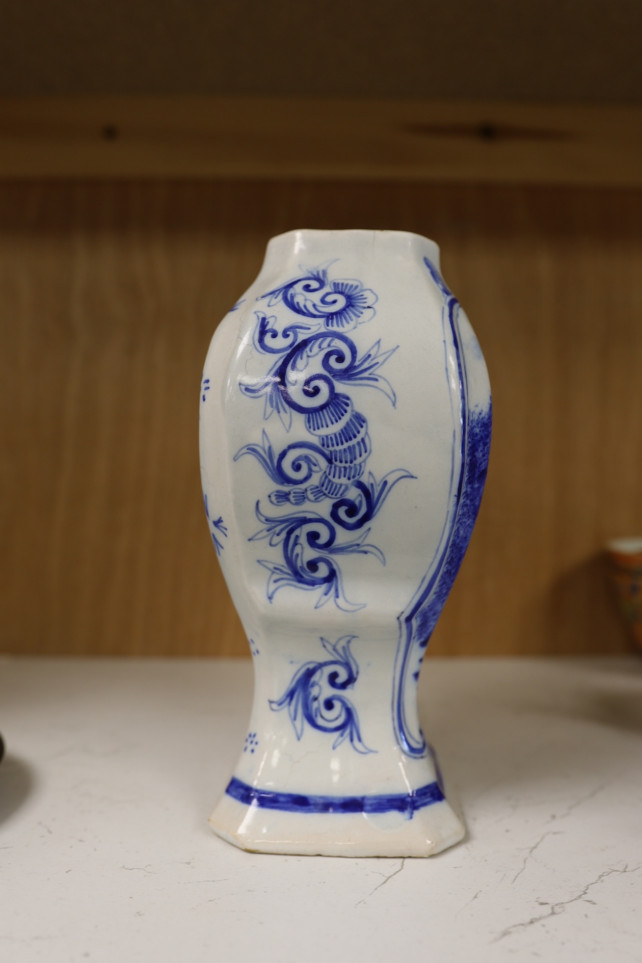 A 19th century Delft blue and white vase and a Watcombe Torquay pottery chamberstick, 19.5cm. Condition - both fair